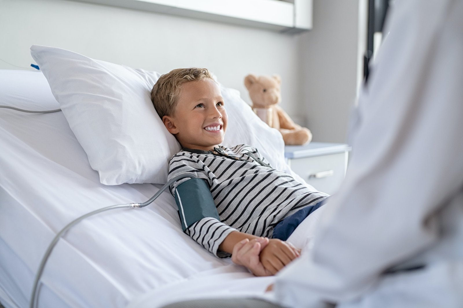 Cute boy lying on hospital bed